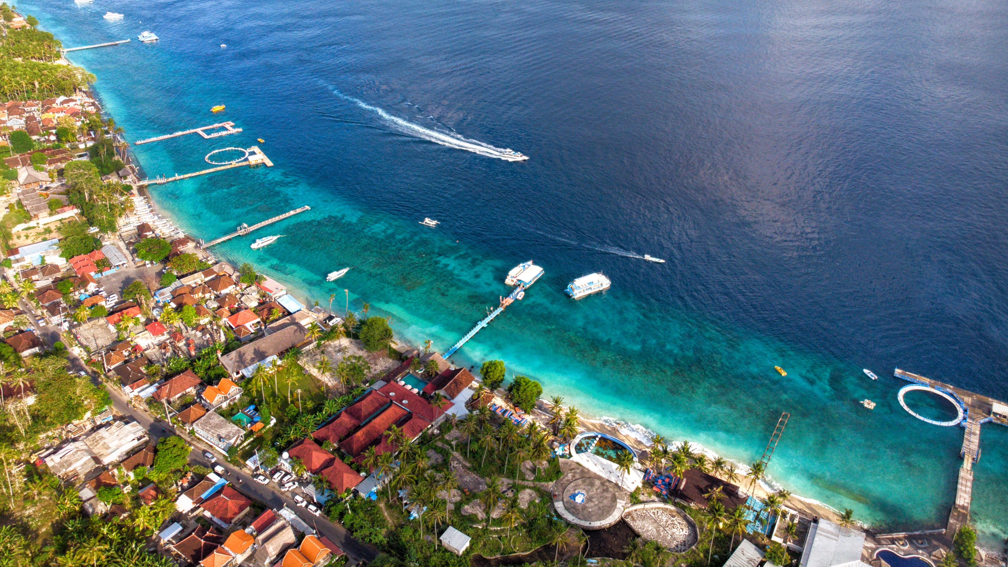 Volcanic sea stacks and azure ocean surf in Nusa Penida, Bali, Indonesia seen from 198 metres above ground level