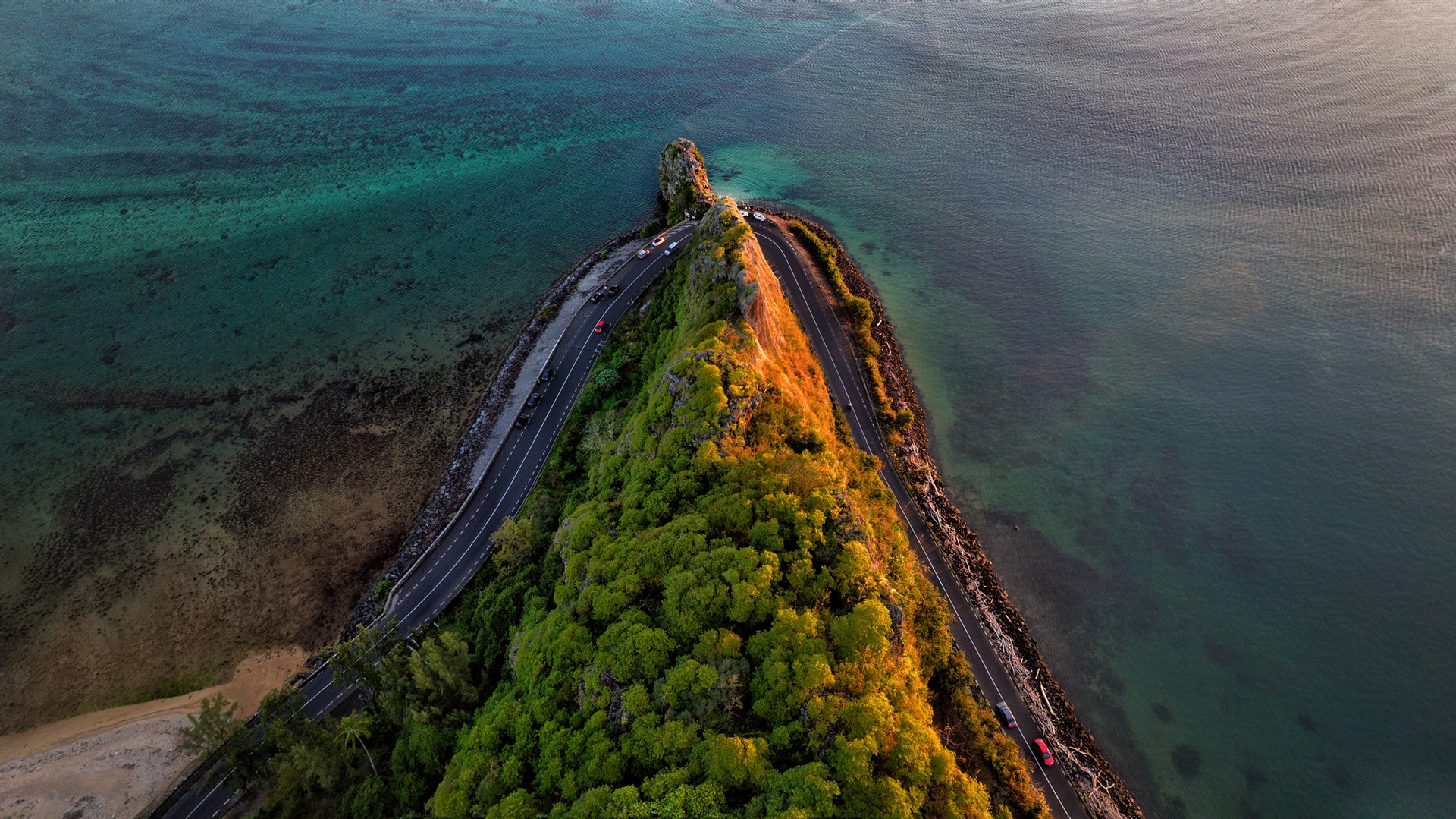 Aerial view of Macondé Peak hairpin ridge and turquoise lagoon in Mauritius